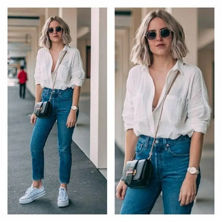 Woman wearing a casual everyday outfit with a white T-shirt, straight-leg jeans, white sneakers, and a crossbody bag as part of a capsule wardrobe.