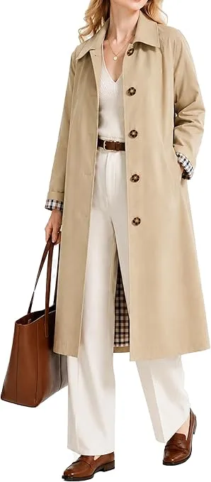 Woman wearing a beige trench coat layered over a classic outfit for a timeless old money capsule wardrobe look.