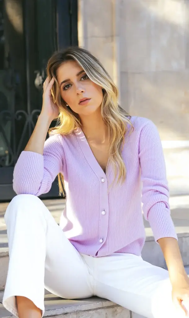 Pink cashmere sweater styled with blue jeans for an elegant everyday outfit