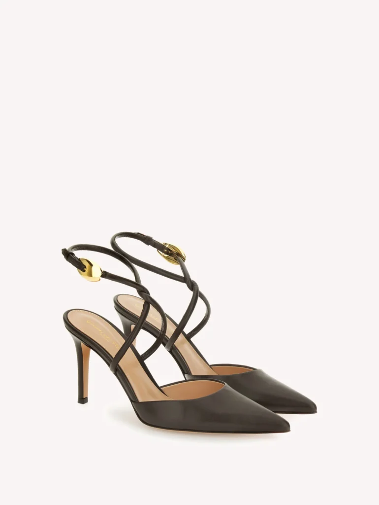 Black pointed-toe slingback pumps with slim heels and ankle straps