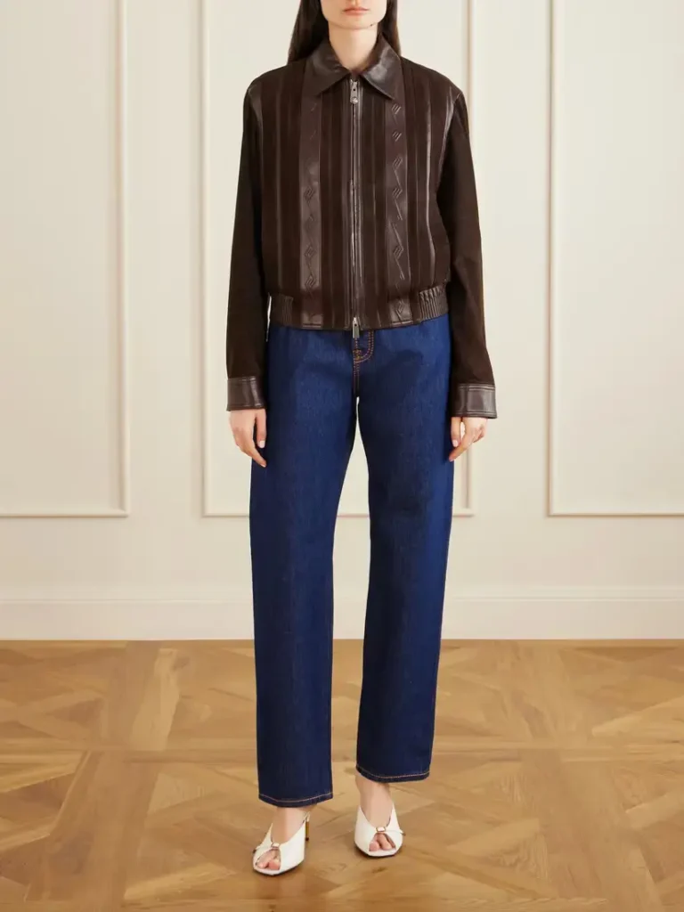Straight-leg blue jeans styled with a brown leather jacket and heels