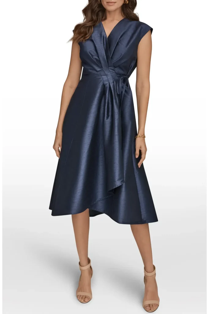 Navy wrap midi dress styled with neutral heels for a polished elegant look