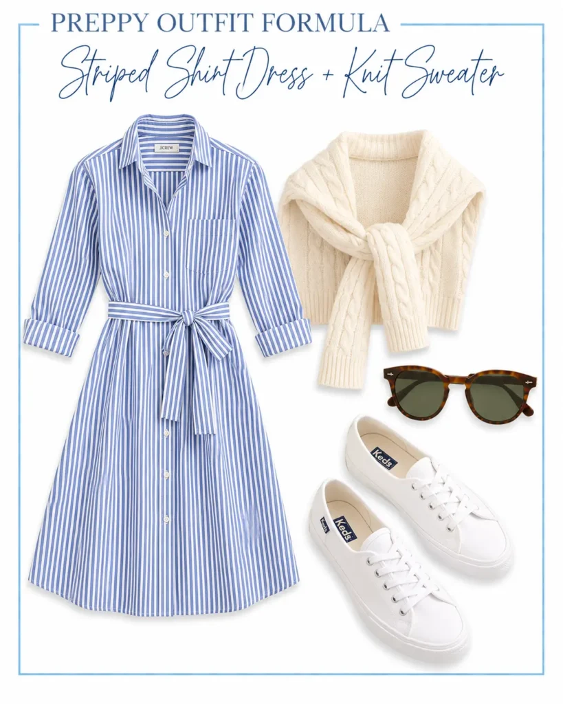 Casual preppy outfit featuring a blue and white striped shirt dress, cream cable-knit sweater, white sneakers, and tortoiseshell sunglasses.